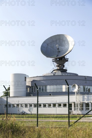 Barbed wire fence around satellite links center with telecommunication tower equipped with radar antennas, cybercrime and cybersecurity concept Prague, Czech republic