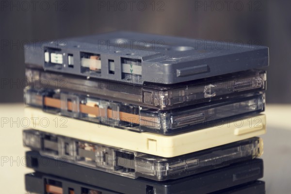 Filtered retro compact cassette audio magnetic tapes on wooden background