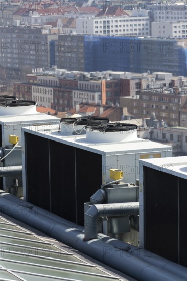 Air conditioning ventilators on roof with houses in background Prague Czech republic
