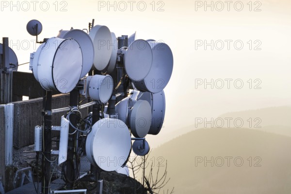 Transmitters and aerials on telecommunication tower during sunset Liberec Czech republic