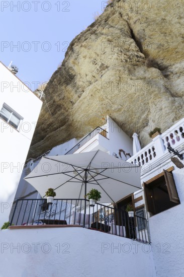 Setenil de las bodegas, cadiz, spain SWhitewashed houses of setenil de las bodegas, spain, built into a large cliff overhang, creating unique cave dwellings and terraces