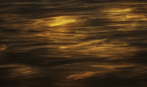 The image is of a body of water with a brownish hue. The water appears to be rippling and has a somewhat murky appearance. AI generated