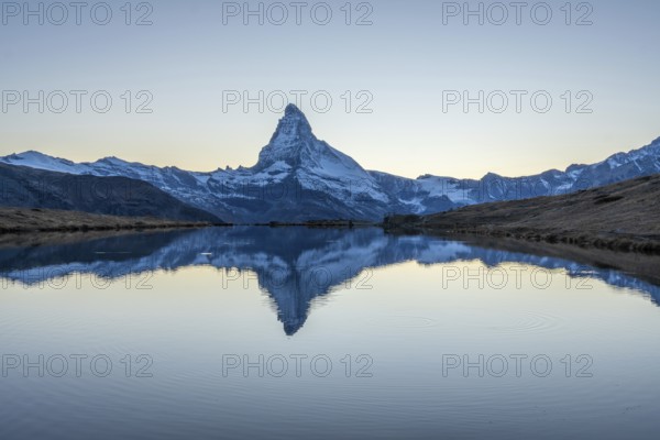 Matterhorn Mountain and Reflection in Lake Stellisee in Evening Twilight. Swiss Alps. Valais, Switzerland
