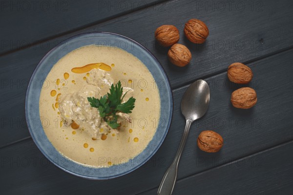 Satsivi, Georgian dish, chicken in nut sauce, cold appetizer, on a wooden table, no people, homemade