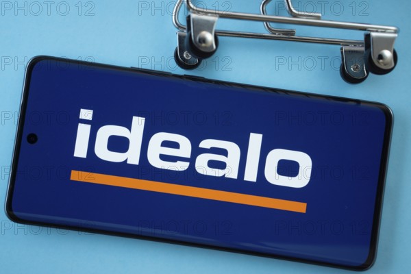 Dhaka, Bangladesh- 03 July 2025: Smartphone screen showing the idealo logo with shopping cart wheels on a blue background
