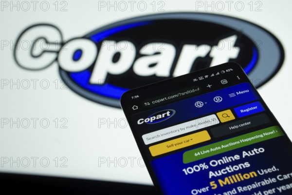Dhaka, Bangladesh- 03 July 2025: Smartphone displaying Copart web interface against Copart logo background