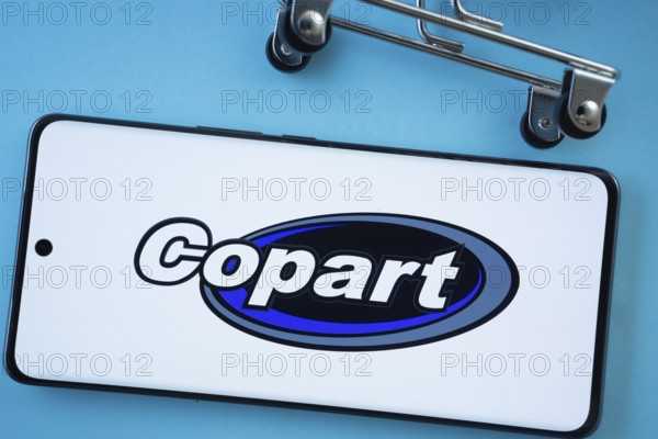 Dhaka, Bangladesh- 03 July 2025: Smartphone screen showing the Copart logo with shopping cart wheels on a blue background