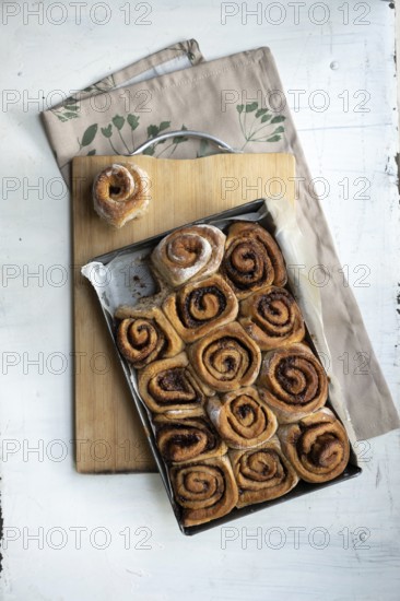 Freshly baked cinnamon rolls on a wooden board