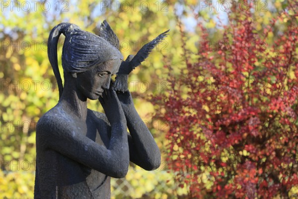 Statue of woman with dove on grave, cemetery, Lüdersen mountain village, city of Springe, Hanover region, Lower Saxony, Germany