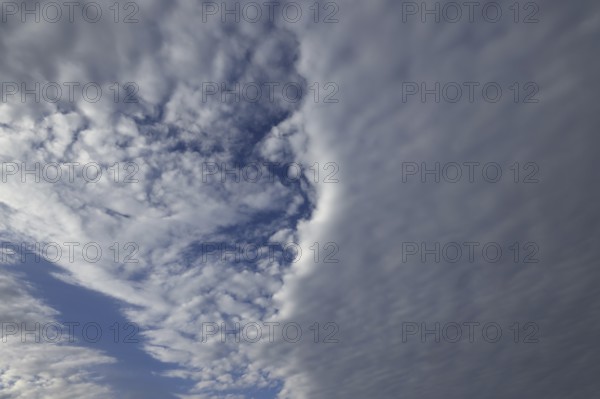 A low-lying closed cloud cover divides the sky into two parts, Upper Bavaria, Bavaria, Germany