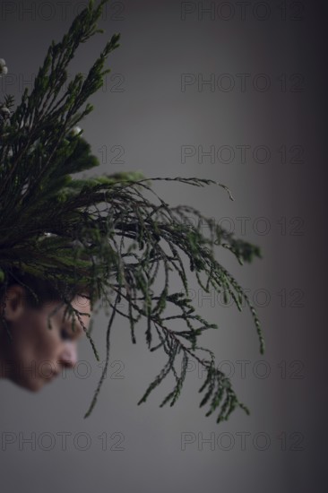 Head of woman behind ostrich with grasses
