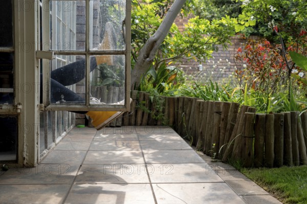 Legs sticking out of a window, garden view