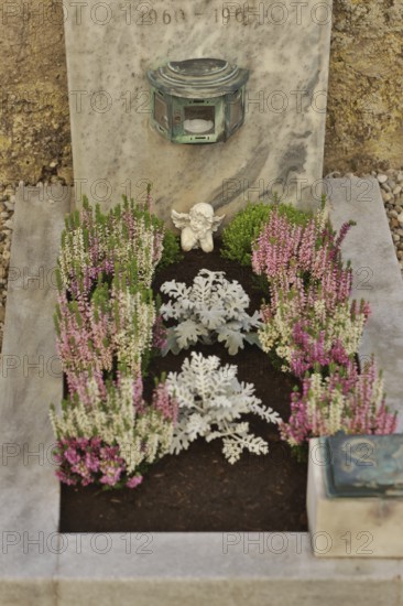 Children's grave with angel figure and beautiful flower decoration for All Saints on a cemetery wall, Upper Bavaria, Bavaria, Germany