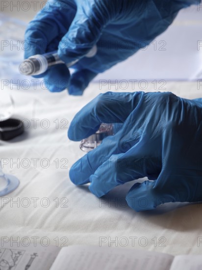 Stambul, Turkey October 21st 2025 Hands in blue gloves preparing a syringe and medication for Sandostatin anti growth hormone injection, focusing on patient care