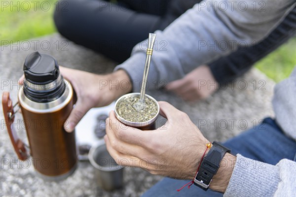 Close up of hands preparing and holding hot mate beverage