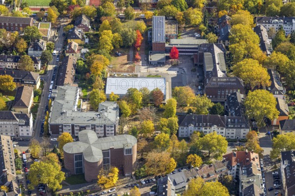 Aerial view, Maria-Wächtler-Gymnasium, below catholic church of St. Andreas, autumn trees, Rüttenscheid, Essen, Ruhr region, North Rhine-Westphalia, Germany, place of worship, education, educational institution, trees in autumn colors, DE, Europe, religious community, church, teaching institute, aerial photography, religion, religious place, school, overview, bird's eye view, birds-eyes view, overview