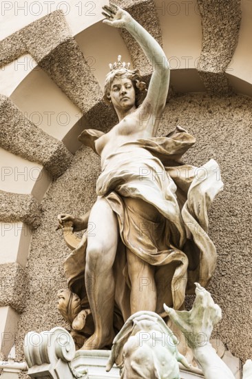 Marble statue of a crowned woman on the façade of the Hofburg Imperial Palace, Vienna, Austria