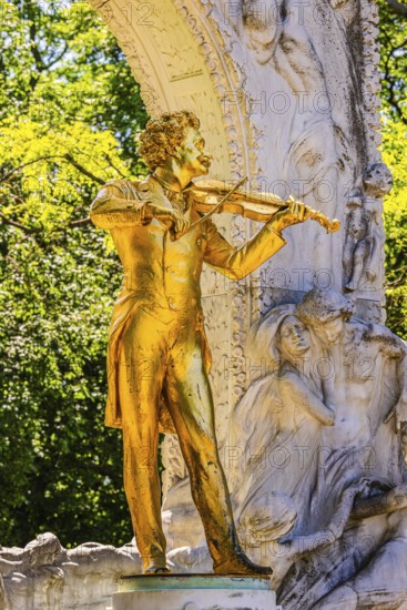 The gilded bronze statue of Johann Strauss, the Waltz King, memorial in the municipal park, Vienna, Austria