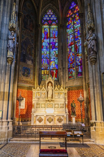 The altar and colorful windows in the neo-gothic votive church, Vienna, Austria