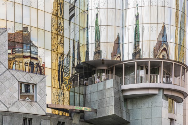 Historic buildings are reflected in the glass façade of the Haas House, Stephansplatz, Vienna, Austria