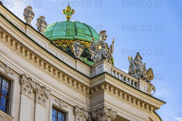 Dome with pompous figures on the roof of the Hofburg Imperial Palace, Vienna, Austria