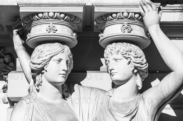 Women as supporting marble statues at a historic building, black and white photo, Josefsplatz, Vienna, Austria