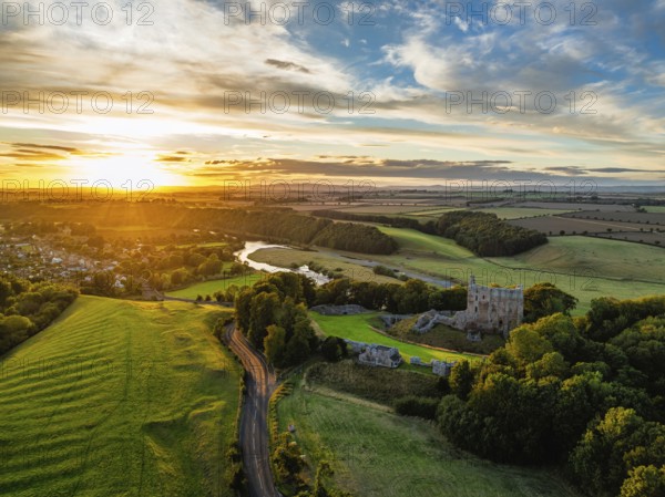 Sunset over Norham Castle and River Tweed from a drone, Norham, Northumberland, England, United Kingdom