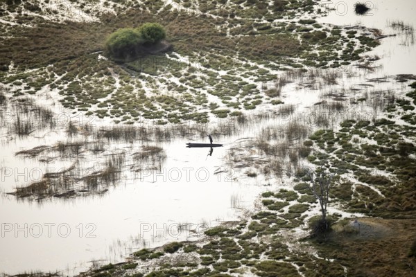 Marshland, marshland with canals, Kavango fishermen with his Mokoro, aerial view, Okavango Delta, Botswana