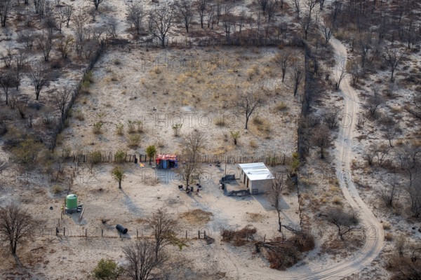 Houses in a dry savanna landscape, near Maun, aerial view, Okavango Delta, Botswana