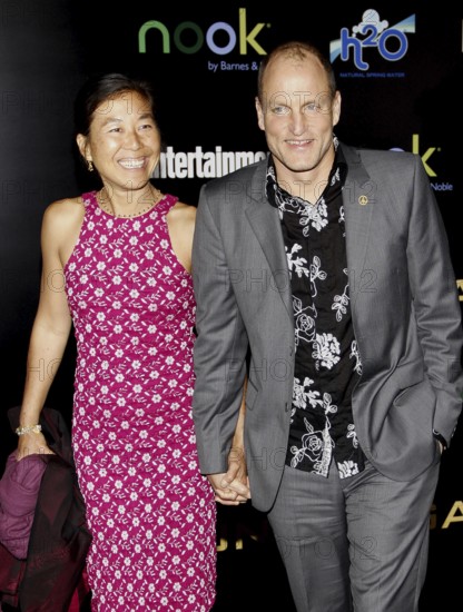 Woody Harrelson and Laura Louie at the Los Angeles premiere of 'The Hunger Games' held at the Nokia Theatre L.A. Live in Los Angeles on March 12, 2012, Los Angeles, CA, USA, Los Angeles, California, USA