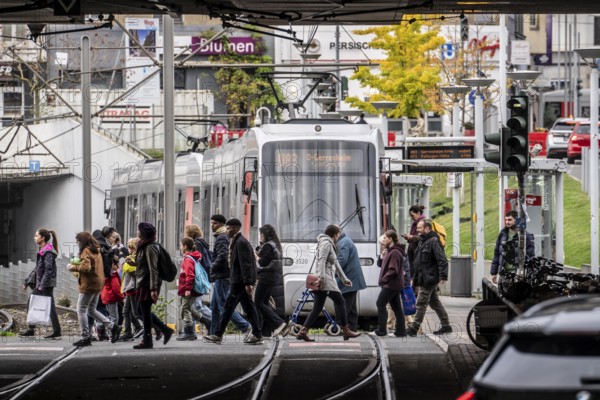 Pedestrians cross the tram tracks, at Düsseldorf-Bilk station, junction of S-Bahn, subway, tram, local bus transport, North Rhine-Westphalia