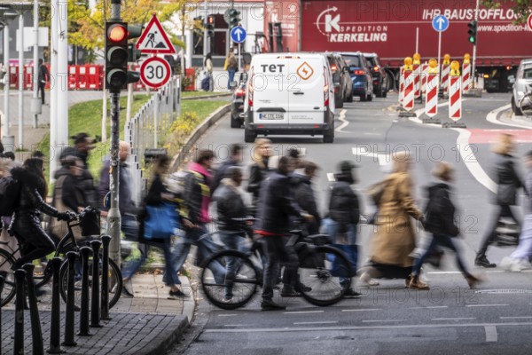 Pedestrians at Düsseldorf-Bilk train station, cross Friedrichstraße at a pedestrian crossing with traffic lights, North Rhine-Westphalia
