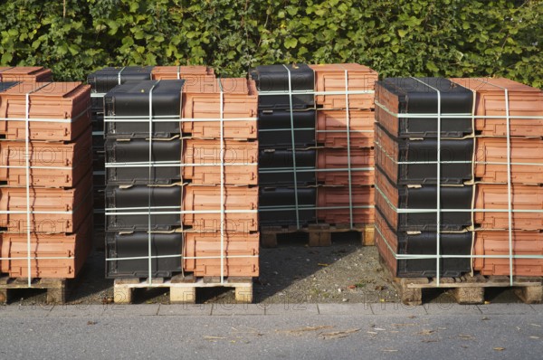 Borken, NRW, Germany, RBundled roof tiles on wooden pallets for construction or renovation