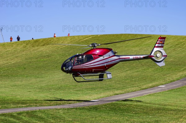 A Eurocopter EC 120B Colibri helicopter, D-HALX registration, during a flight demonstration as part of an air show on Rossfeld in Metzingen-Glems, Baden-Württemberg, Germany, for editorial use only