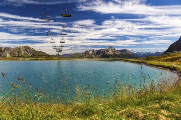 The panoramic lake on Saloberkopf with cable car and mountains in the background under a blue sky, Wart, Bregenz, Vorarlberg, Austria