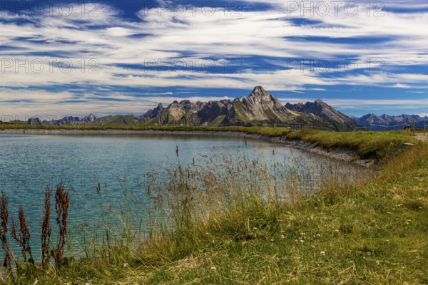 The panoramic lake at Saloberkopf with mountains in the background under a blue sky, Wart, Bregenz, Vorarlberg, Austria