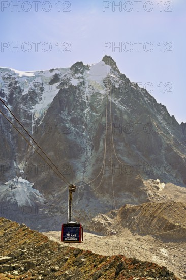 View of the arriving cable car from the Plan de l'Aiguille middle station, in the back the mountain station of the Aiguille du Midi, Chamonix-Mont-Blanc, Haute-Savoie, France