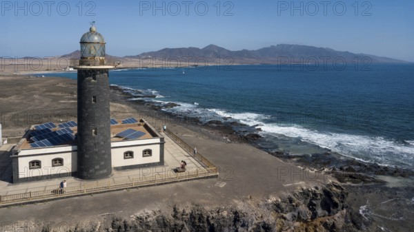Aerial view of Faro Punta de Jandia lighthouse on a rocky outcrop at the southern tip of Jandia Peninsula, Fuerteventura, Canary Islands, Spain