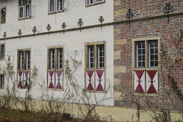 Historic façade with brick, lattice windows and red and white shops in a quiet autumn atmosphere, North Rhine-Westphalia, Germany