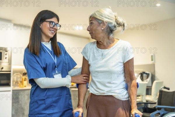 Professional caregiver in uniform supporting an elderly woman using crutches, providing assistance and fostering rehabilitation and health in a home environment