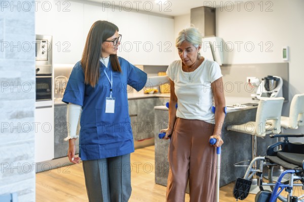 Home care nurse supports elderly woman with crutches during rehabilitation exercises at home, promoting mobility, recovery, independence and compassionate physical therapy
