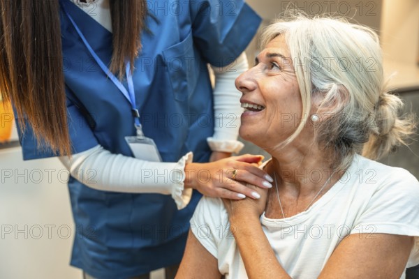 Healthcare worker in scrubs providing comforting support to a smiling senior woman, symbolizing care, trust, and empathy in medicine and patient well being
