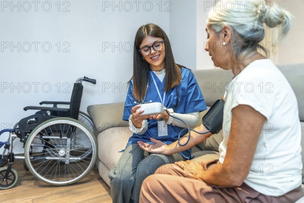 Healthcare professional checking blood pressure for an elderly patient while providing medical assistance and home care services, ensuring well being and health monitoring
