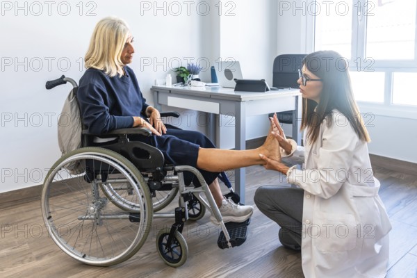 Female doctor examining an elderly woman's foot during a rehabilitation session, focusing on physiotherapy and healthcare assistance for people with disabilities