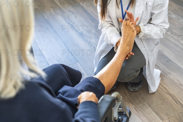 Medical professional in a white lab coat examining a senior patient's bare foot, providing care and assistance during a physiotherapy or rehabilitation session at home