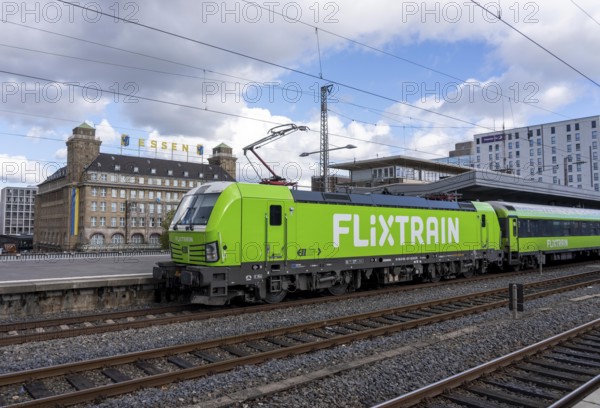 Flixtrain train on track 2 in Essen main station, view of the city center, Handelshof building with Essen lettering, North Rhine-Westphalia, Germany
