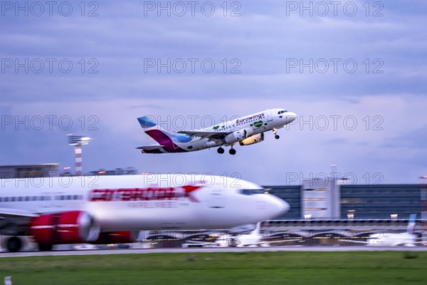 Corendon Airlines Boeing 737-800 landing at Düsseldorf airport, Eurowings Airbus taking off, North Rhine-Westphalia, Germany