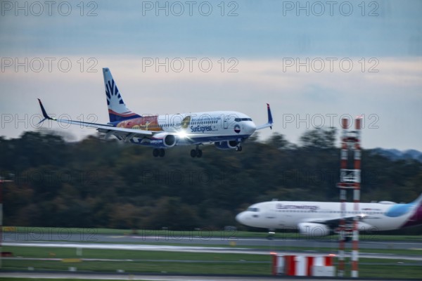 Sunexpress Boeing 737 landing at Düsseldorf airport, Eurowings aircraft waiting for takeoff, North Rhine-Westphalia, Germany