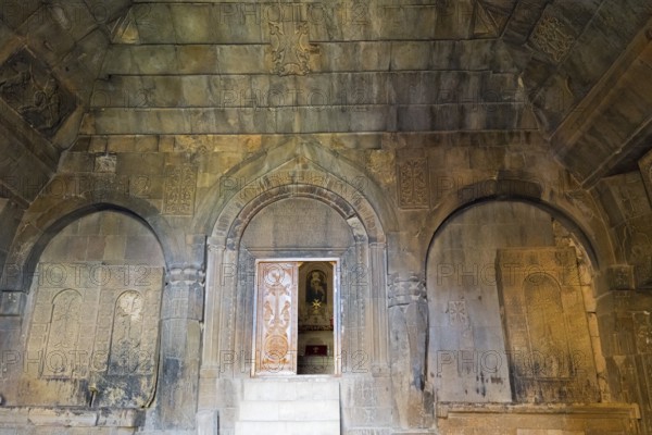 Detail of an ancient stone building with wall engravings and reliefs that conveys a historically religious atmosphere, Noravank Surb Karapet Baptist Church, Vayots Dzor Province, Vayots Dzor, Armenia, Caucasus