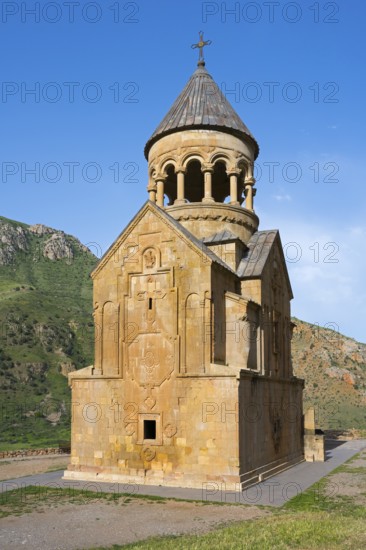 A church with ornate stone architecture against a clear blue sky, Noravank monastery, Surb Astvatsatsin mausoleum church, Noravank, Vayots Dzor province, Wajoz Dzor, Armenia, Caucasus